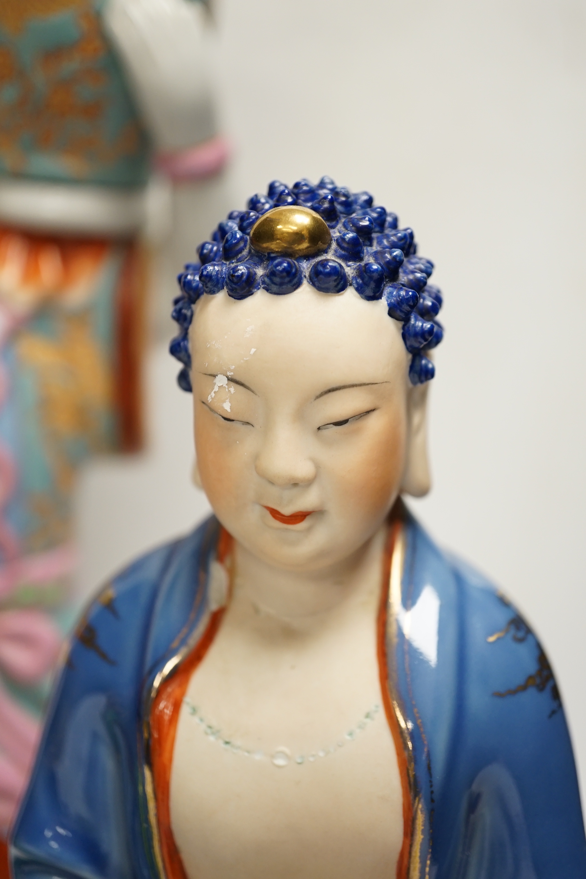 Five Chinese figures of Buddha or Budai, including a hardwood example, largest 38cm high